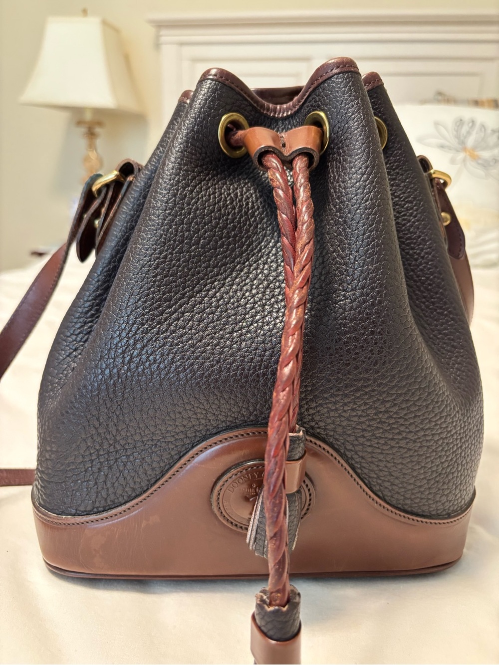 Dooney & Bourke Black Pebbled Leather Drawstring Bucket Bag with Brown Trim